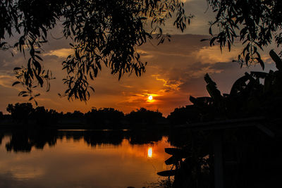 Scenic view of lake against orange sky