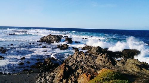 Scenic view of sea against clear blue sky