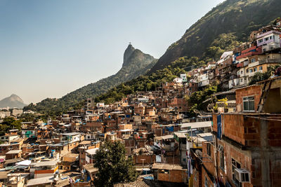 Town by mountains against clear sky