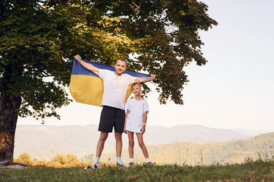 Rear view of woman standing on field