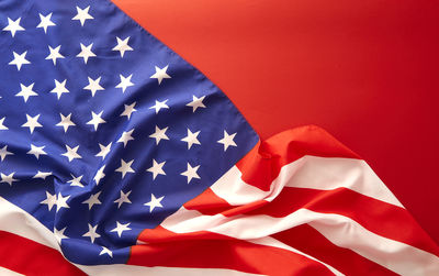 Close-up of american flag against red background