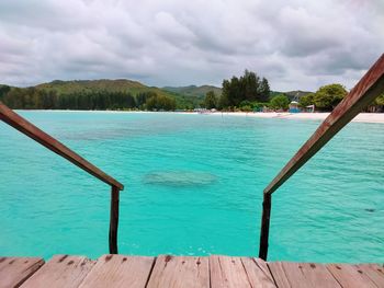 Scenic view of swimming pool by sea against sky