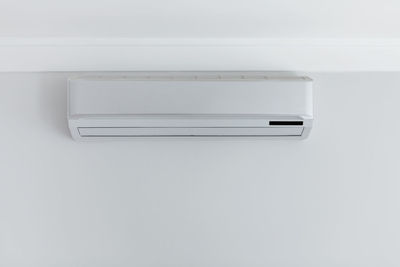 Close-up of electric fan against white background