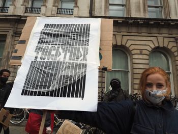 Portrait of man standing against building