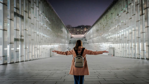 Full length of woman standing on walkway in city