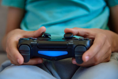 Boy playing video game at home