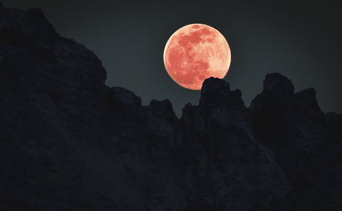 Low angle view of rock formation against sky at night