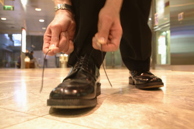 Low section of man standing on floor