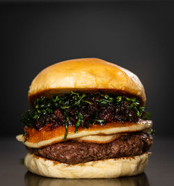 Close-up of burger against black background