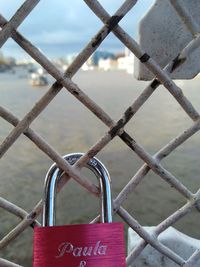 Close-up of padlocks on fence