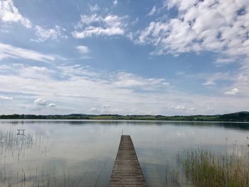 Pier over lake against sky