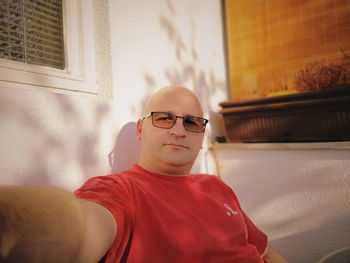 Portrait of mid adult man sitting at home
