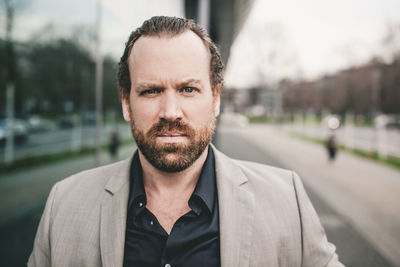 Portrait of businessman standing outdoors