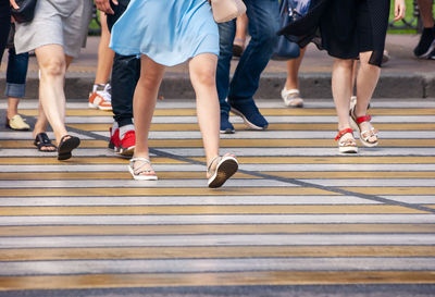 Low section of people walking on road