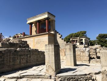 Low angle view of old ruins against blue sky