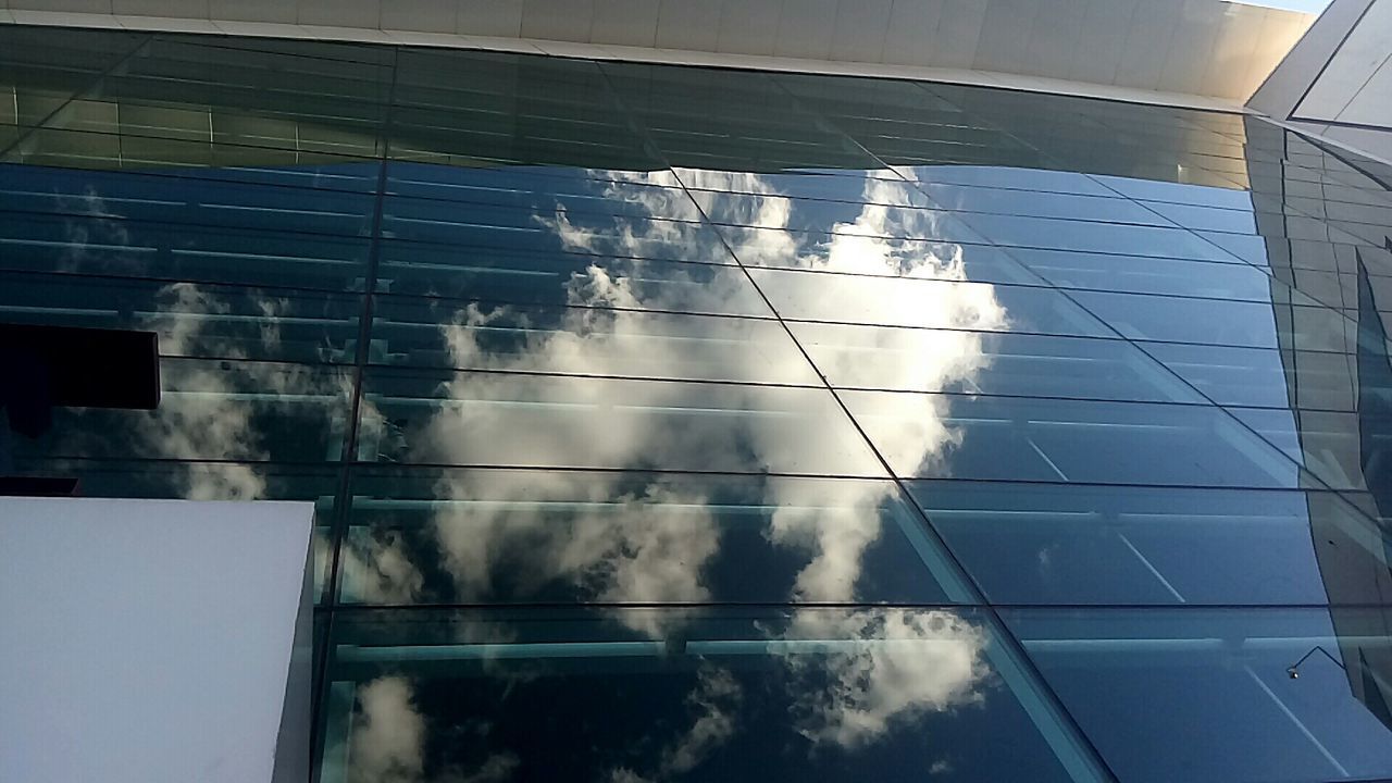 REFLECTION OF BUILDING ON GLASS WINDOW