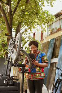 Portrait of smiling young woman riding bicycle