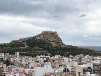 Buildings in town against sky