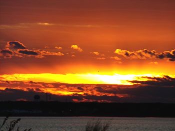 Scenic view of dramatic sky over sea during sunset