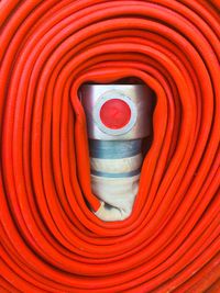 Full frame shot of rolled orange fire hose