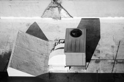 Close-up of old telephone on table against wall