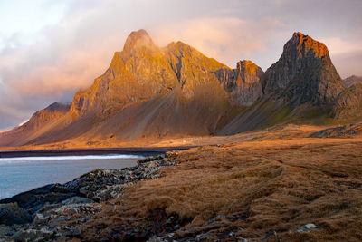 Scenic view of sea and mountains against sky