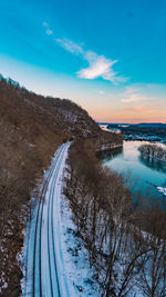 Scenic view of lake against sky during winter