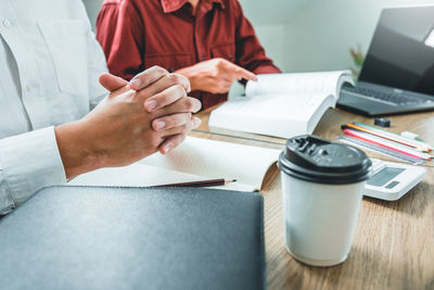 Midsection of man working in office