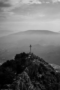 Man standing on mountain against sky