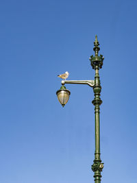 Low angle view of street light against clear blue sky