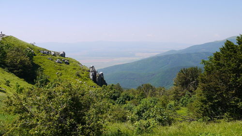 Scenic view of mountain range against blue sky