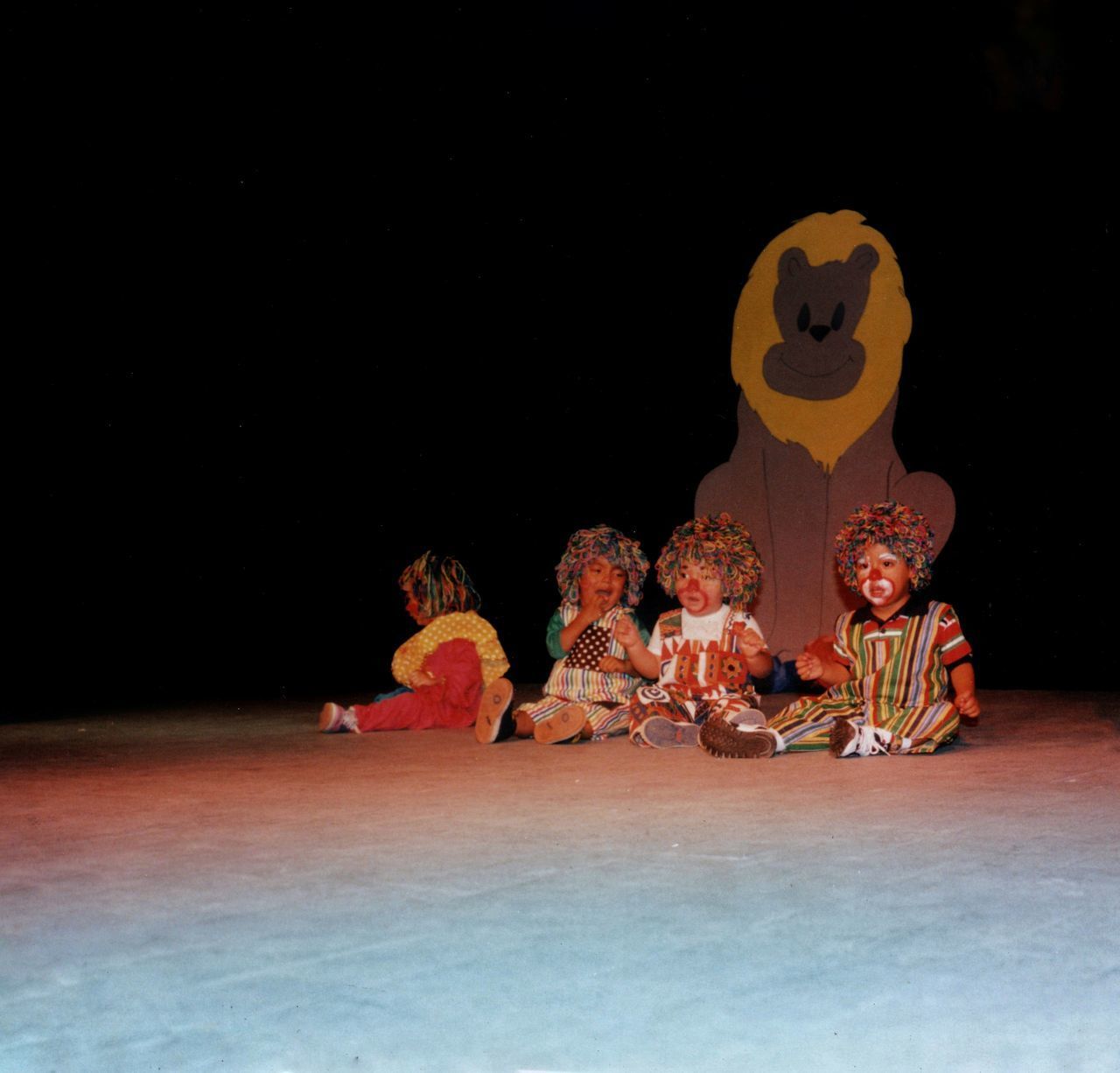 PEOPLE SITTING ON TABLE AGAINST BLACK BACKGROUND WITH REFLECTION