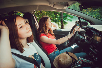 Young woman sitting in car