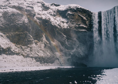 Scenic view of waterfall against sky