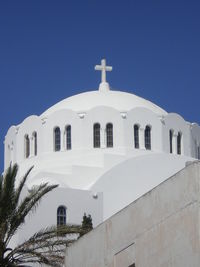 Low angle view of white building against clear blue sky