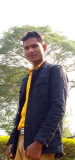 Portrait of young man standing on land