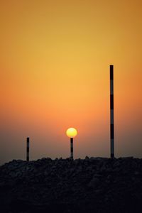 Silhouette rocks against orange sky