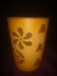 Close-up of yellow glass on table