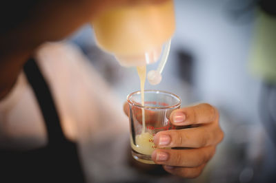 Midsection of man holding wineglass