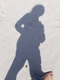 Shadow of man on sand