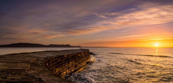 Scenic view of sea against sky at sunset