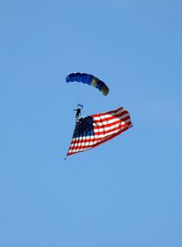 Low angle view of flag against clear blue sky