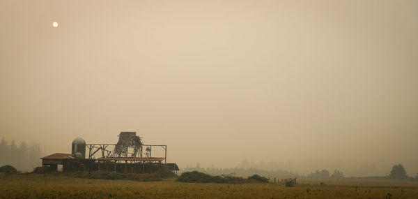 Traditional windmill on field against clear sky