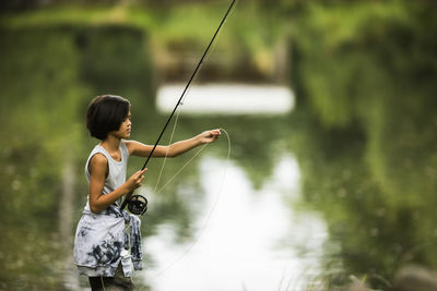 View of boy fishing
