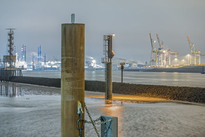 Commercial dock by sea against sky