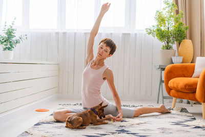 Concept healthy lifestyle. yoga and fitness. cute woman with small dog