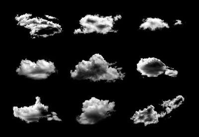 Low angle view of clouds in sky over black background