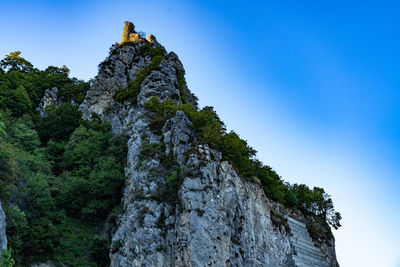 Low angle view of rock formation against sky