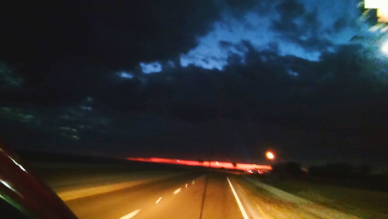 ILLUMINATED LIGHT TRAILS ON ROAD AT NIGHT