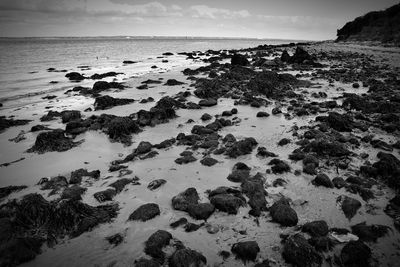 Scenic view of calm sea against cloudy sky